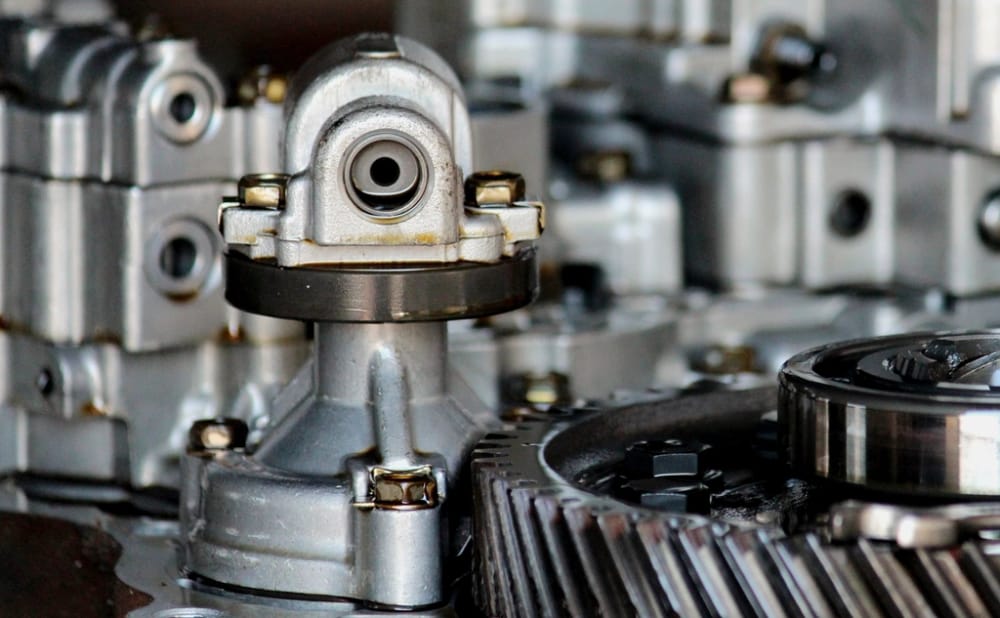 Close detail of a machined aluminium gearbox housing with helical gears.